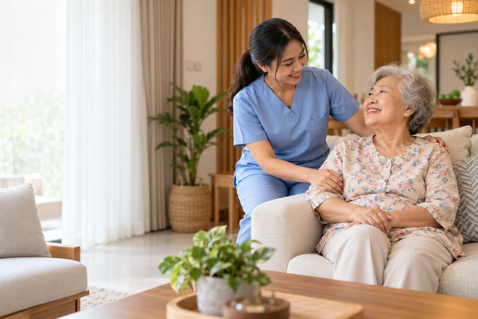Private caregiver supporting an older woman at home in Malaysia